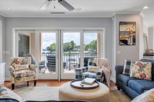 a living room with a couch and chairs and a balcony at Lake Stardust - Condo with pool ! Pet friendly in Moneta