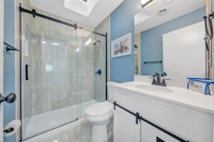 a bathroom with a shower and a toilet and a sink at Sundance - Lakefront w/ Private Dock in Moneta +26 photos