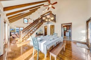 a dining room with a table and chairs and a staircase at Pine Knob Point - Lakehouse w/ Private Dock in Moneta