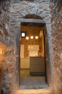 a view of a kitchen through a stone wall at Armathia Accommodation in Mestá