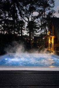a hot tub with steam coming out of it at Alpina Village, Jacuzzi Climatizado, Montaña, Fogata, Jarabacoa in Jarabacoa
