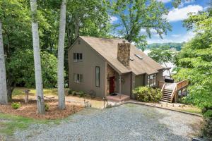 a small house in the middle of the woods at Sundance - Lakefront w/ Private Dock in Moneta