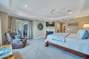 a large bedroom with a bed and a chair at Lake Stardust - Condo with pool ! Pet friendly in Moneta