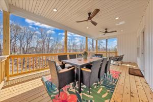 a dining room with a table and chairs on a deck at Lake Twin Cove - New! in Moneta