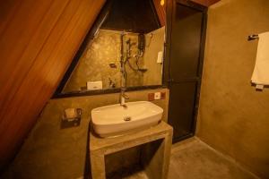 a bathroom with a sink and a shower at Green Infinity Resort in Diyatalawa