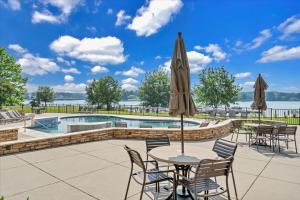 a patio with a table and chairs and a pool at Lake Stardust - Condo with pool ! Pet friendly in Moneta