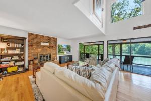 a living room with a large couch and a fireplace at Emerald Shores - Lakefront, Private Dock & Fire Pit in Moneta