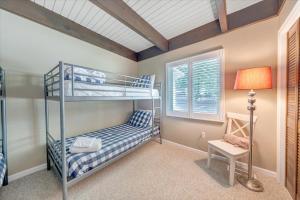 a bedroom with two bunk beds and a lamp at Summer Breeze - Lakefront w/ Private Dock! in Moneta