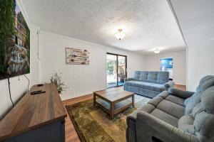 a living room with a couch and a table at Emerald Shores - Lakefront, Private Dock & Fire Pit in Moneta