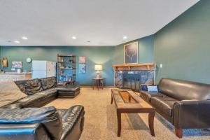 a living room with a leather couch and a fireplace at Whisper Haven - Private dock & Pet friendly in Moneta
