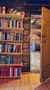 a room filled with shelves filled with books at Håholmen - by Classic Norway Hotels in Karvåg