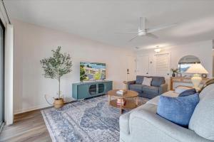 a living room with a couch and a table at Lake Vibes - Pet Friendly Lakefront Condo! in Moneta