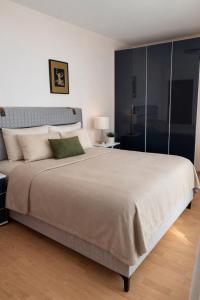 a bedroom with a large bed with a large white bedspread at Sveti Vlas Fort Noks Panorama SAS in Sveti Vlas +43 photos