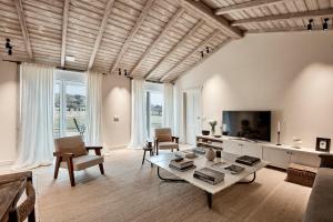 a living room with a table and a tv at Casa Do Gaiteiro in Melide