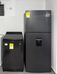 a black refrigerator and a trash can next to a wall at Apartamento exclusivo en ricaurte Cundinamarca in Ricaurte +11 photos