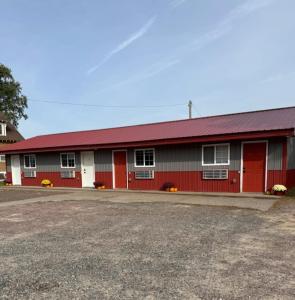 a red and white building with a red roof at A Night In Northfield in Hixton