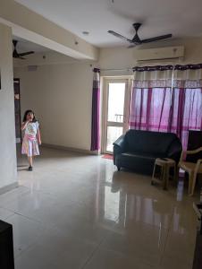 a little girl standing in a living room at Panchsheel Greens 2 in Ghaziabad