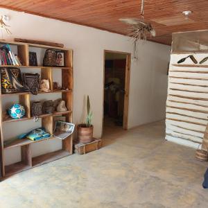 a living room with shelves and a ceiling at Hostel Nugeku in Rincón