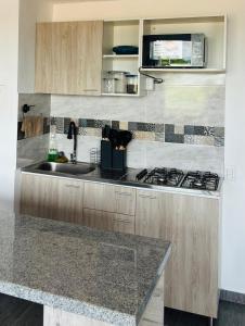 a kitchen with a sink and a stove at Apartamento exclusivo en ricaurte Cundinamarca in Ricaurte