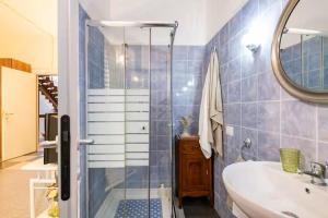 a bathroom with a shower and a sink and a tub at Appartamenti Milù - Milù Holidays La Maddalena in La Maddalena +138 photos