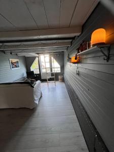 a room with a bed and a room with a window at Villa Vannes in Skånevik
