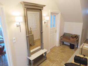 a hallway with a large mirror on the wall at Bauernhaus Premium in Fehmarn +17 photos