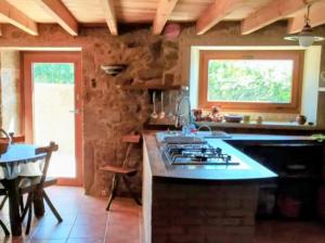 a kitchen with a stove and a counter top at Casa Candy in Muxia +18 photos
