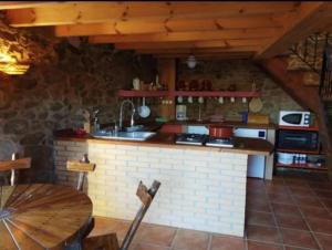 a kitchen with a sink and a counter in a room at Casa Candy in Muxia