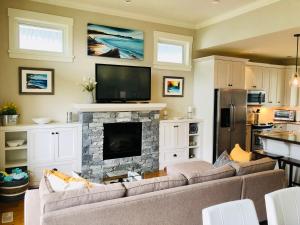 a living room with a couch and a fireplace at Qualicum Landing Seaside Vill in Qualicum Beach