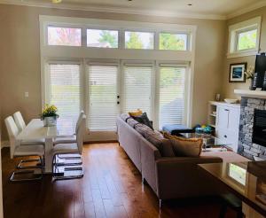a living room with a couch and a table at Qualicum Landing Seaside Vill in Qualicum Beach