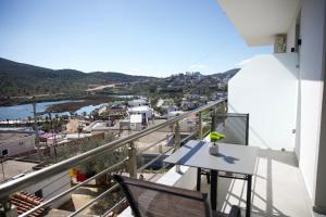 a balcony with a table and chairs and a river at Vila Lori in Ksamil