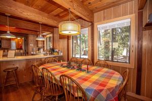 a dining room with a table and chairs and a kitchen at Das Berghaus By Hauserman Rentals in Tahoe City
