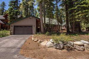 a house with a garage and a driveway at Das Berghaus By Hauserman Rentals in Tahoe City