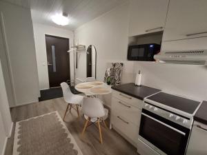a kitchen with a table and chairs in a room at Easy Stay Mikkeli in Mikkeli