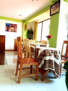a dining room with a table and chairs at Hostal Iskanwaya in La Paz