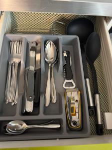 a tray filled with utensils in a drawer at Studio Mulhouse in Mulhouse