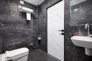 a bathroom with a toilet and a sink at Planet Eco Stays - Near Mahakal Temple in Ujjain +20 photos