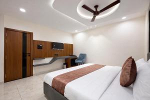 a bedroom with a bed and a ceiling fan at Planet Eco Stays - Near Mahakal Temple in Ujjain