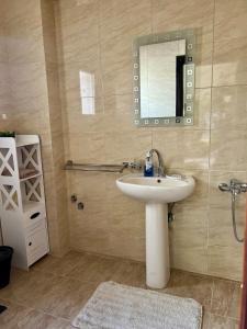 a bathroom with a sink and a mirror at Yousrys Nest Cozy Rooftop Studio in New cairo +18 photos