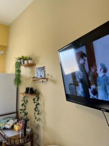 a flat screen tv hanging on a wall at Yousrys Nest Cozy Rooftop Studio in New cairo