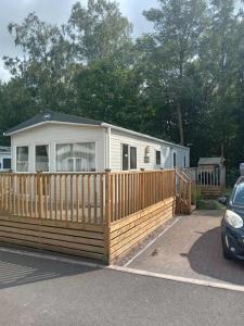 a mobile home with a wooden fence at The retreat in Carlisle