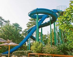 a blue water slide in a park at Villa bord de mer in Labenne