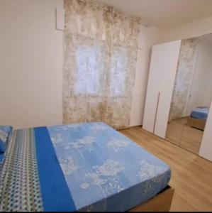 a bedroom with a blue bed in a room at Casa Margherita in Castelfidardo