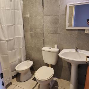 a bathroom with a toilet and a sink at Duplex Parking free in Estación Circunvalación