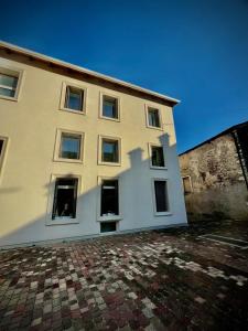 a large white building with windows on the side of it at A Casa di Angelica in Piovene Rocchette