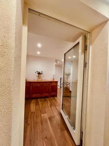 a hallway with a sliding glass door leading to a bathroom at A Casa di Angelica in Piovene Rocchette