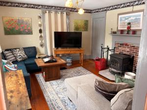 a living room with a couch and a fireplace at My Valhalla Farm-Room Rentals in Oakland