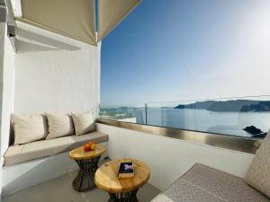 a living room with a couch and a table at Kaleidoscope Cave Houses in Oia