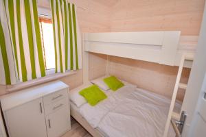 a small room with a bunk bed and a window at Domki Agnes in Darłowo +20 photos