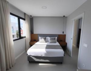 a bedroom with a large bed and a window at Apartamentos Arinaga Ocean View in Arinaga +22 photos
